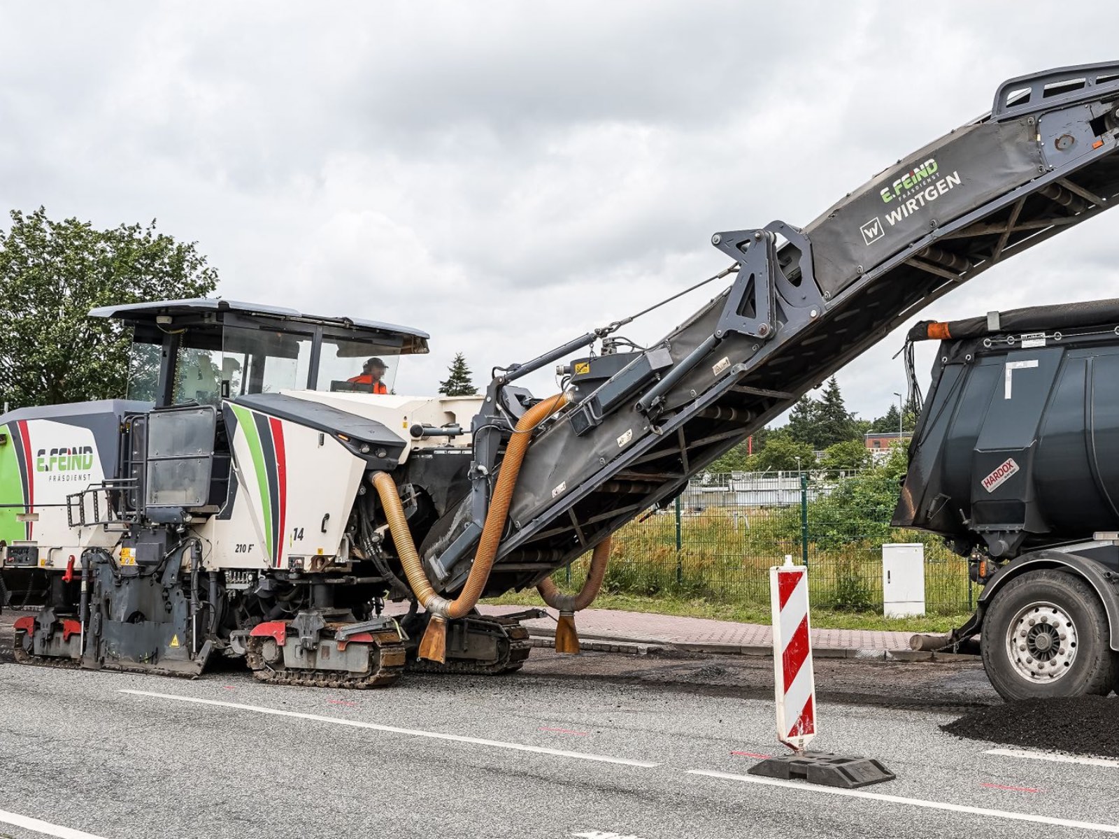 Asphalt milling machine removing old pavement